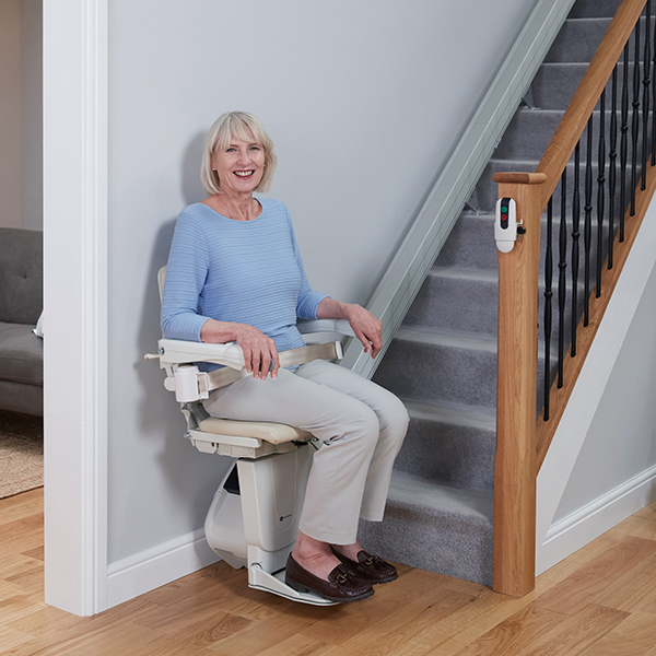 1100 straight stairlift woman in use